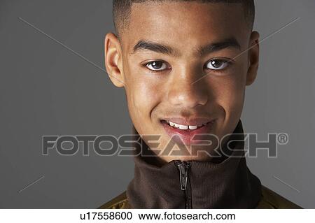 Stock Image - Studio Portrait Of Fashionably Dressed Teenage Boy. Fotosearch