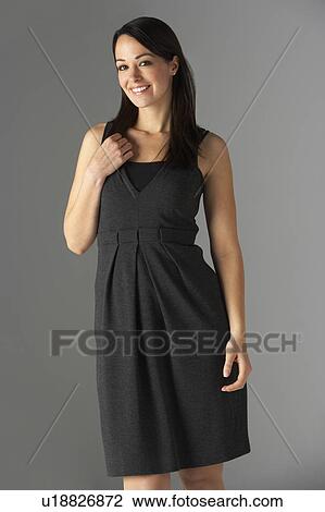 Stock Image - Studio Portrait Of Fashionably Dressed Woman. Fotosearch