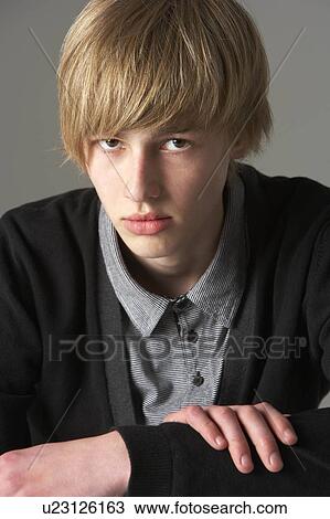 Stock Image - Studio Portrait Of Fashionably Dressed Teenage Boy. Fotosearch