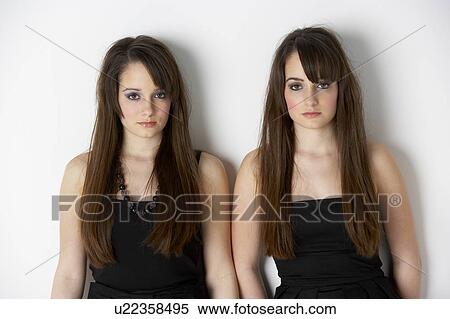 Studio Portrait Of Fashionably Dressed Twin Teenage Girls View Large Photo Image Stock Photography - Studio Portrait Of Fashionably Dressed Twin Teenage Girls. Fotosearch