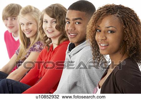 Stock Image - Studio Portrait Of Five Teenage Friends Standing In Line. Fotosearch