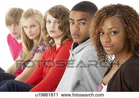 Stock Image - Studio Portrait Of Five Teenage Friends Standing In Line. Fotosearch