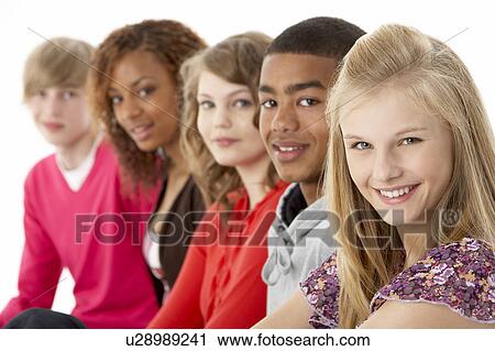 Stock Image - Studio Portrait Of Five Teenage Friends Standing In Line. Fotosearch