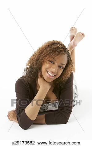 Stock Image - Studio Portrait Of Happy Teenage Girl. Fotosearch