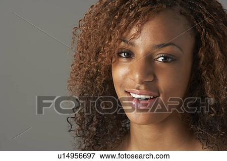 Stock Photo - Studio Portrait Of Happy Teenage Girl. Fotosearch