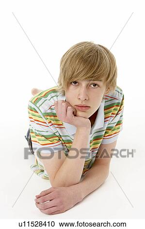 Stock Image - Studio Portrait Of Serious Teenage Boy. Fotosearch