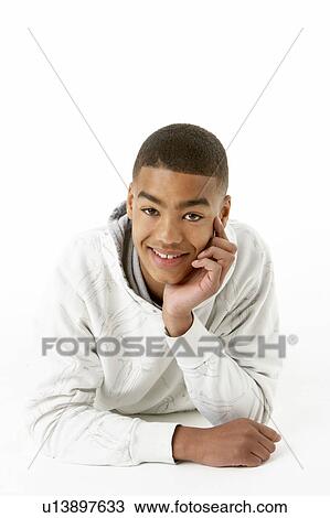 Stock Image - Studio Portrait Of Smiling Teenage Boy. Fotosearch