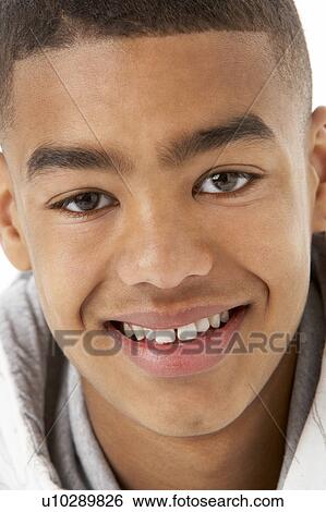 Stock Photograph - Studio Portrait Of Smiling Teenage Boy. Fotosearch