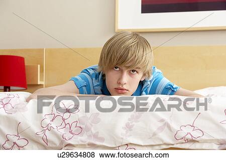 Teenage Boy In Bedroom Looking Sad View Large Photo Image Stock Photo - Teenage Boy In Bedroom Looking Sad. Fotosearch