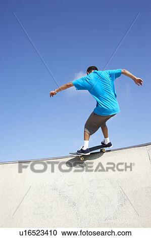 Stock Image - Teenage Boy In Skateboard Park. Fotosearch