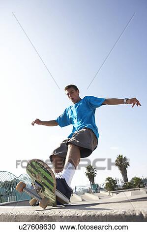 Stock Image - Teenage Boy In Skateboard Park. Fotosearch
