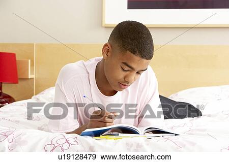 Teenage Boy Writing In Diary In Bedroom View Large Photo Image Stock Photo - Teenage Boy Writing In Diary In Bedroom. Fotosearch