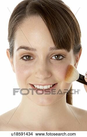 Picture - Teenage Girl Applying Make Up. Fotosearch