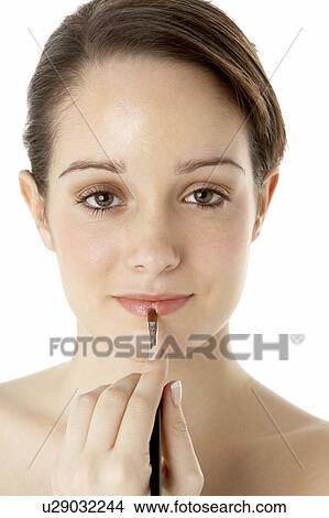 Picture - Teenage Girl Applying Make Up. Fotosearch