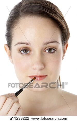 Stock Image - Teenage Girl Applying Make Up. Fotosearch