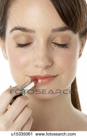 Stock Image - Teenage Girl Applying Make Up. Fotosearch
