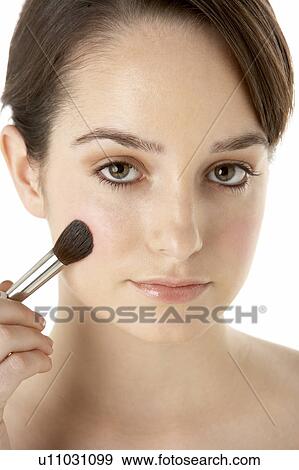 Stock Photo - Teenage Girl Applying Make Up. Fotosearch