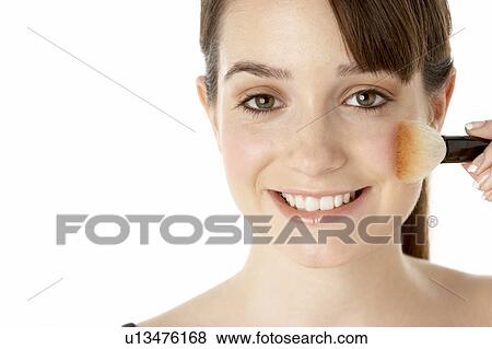 Stock Photo - Teenage Girl Applying Make Up. Fotosearch