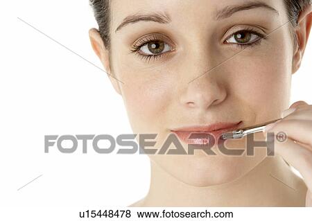 Stock Photo - Teenage Girl Applying Make Up. Fotosearch