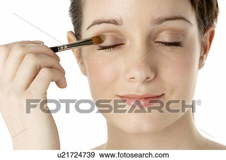 Stock Photo - Teenage Girl Applying Make Up. Fotosearch