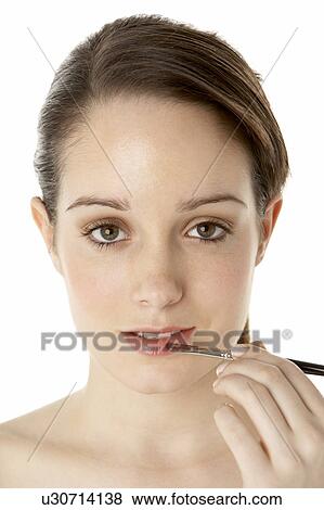 Stock Photo - Teenage Girl Applying Make Up. Fotosearch