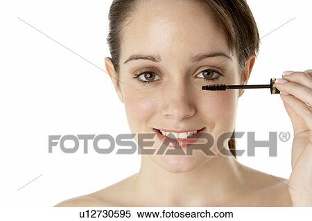Stock Photography - Teenage Girl Applying Make Up. Fotosearch