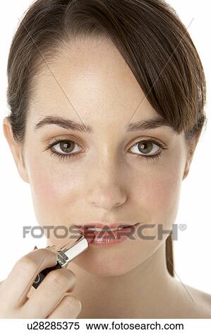 Stock Photography - Teenage Girl Applying Make Up. Fotosearch
