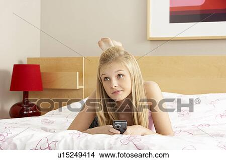 Teenage Girl In Bedroom With Mobile Phone View Large Photo Image Picture - Teenage Girl In Bedroom With Mobile Phone. Fotosearch