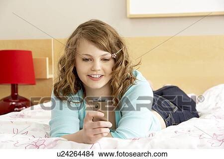 Teenage Girl In Bedroom With Mobile Phone View Large Photo Image Picture - Teenage Girl In Bedroom With Mobile Phone. Fotosearch