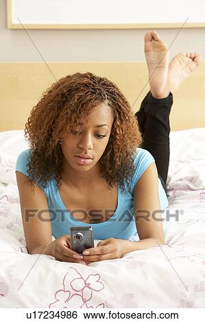 Teenage Girl In Bedroom With Mobile Phone View Large Photo Image Stock Photograph - Teenage Girl In Bedroom With Mobile Phone. Fotosearch
