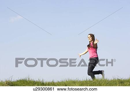 Teenage Girl Running Through Summer Meadow View Large Photo Image Stock Image - Teenage Girl Running Through Summer Meadow. Fotosearch