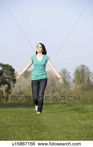 Stock Photograph - Teenage Girl Running Through Summer Meadow. Fotosearch