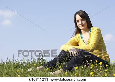 Teenage Girl Sitting In Summer Meadow View Large Photo Image Stock Image - Teenage Girl Sitting In Summer Meadow. Fotosearch