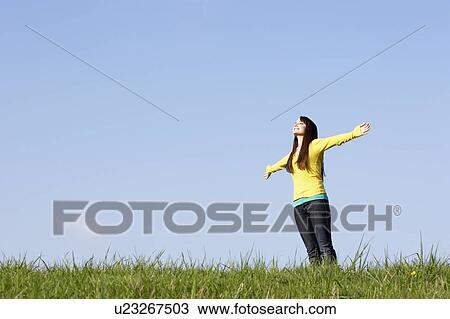 Stock Image - Teenage Girl Standing In Summer Meadow. Fotosearch