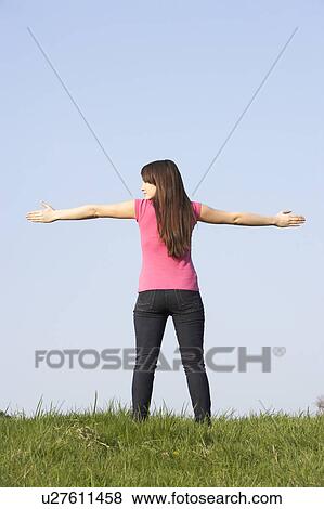 Stock Photo - Teenage Girl Standing In Summer Meadow. Fotosearch