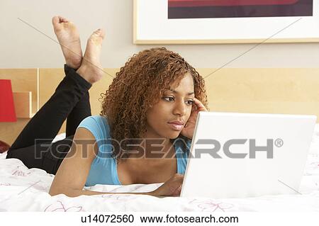 Teenage Girl Using Laptop In Bedroom View Large Photo Image Stock Image - Teenage Girl Using Laptop In Bedroom. Fotosearch
