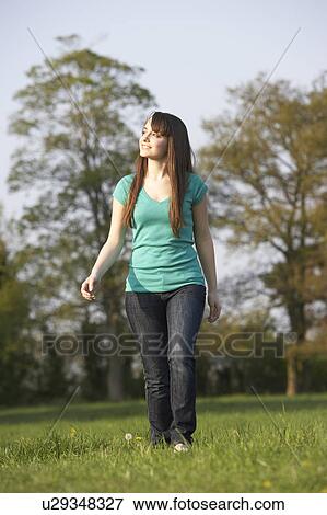 Teenage Girl Walking Through Summer Meadow View Large Photo Image Stock Photo - Teenage Girl Walking Through Summer Meadow. Fotosearch