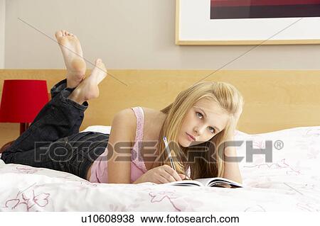 Teenage Girl Writing In Diary In Bedroom View Large Photo Image Stock Photo - Teenage Girl Writing In Diary In Bedroom. Fotosearch