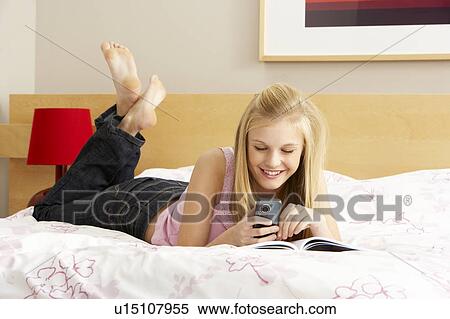 Stock Photography - Teenage Girl Writing In Diary In Bedroom. Fotosearch