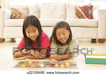 Two Girls Playing Board Game At Home View Large Photo Image Stock Image - Two Girls Playing Board Game At Home. Fotosearch