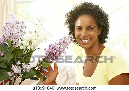 Stock Image - Woman Flower Arranging At Home. Fotosearch