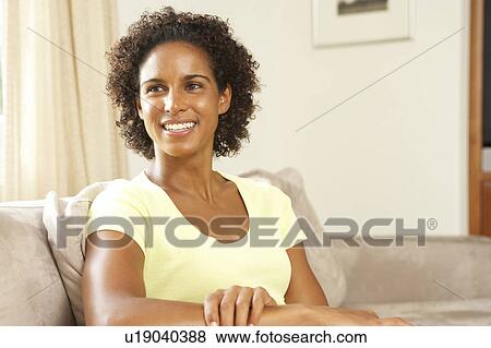 Stock Photo - Woman Relaxing On Sofa At Home. Fotosearch