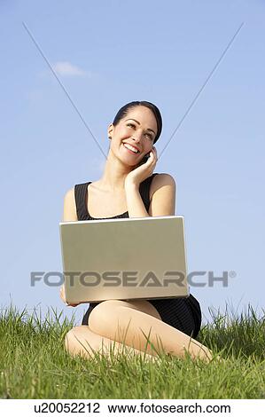 Woman Using Laptop And Mobile Phone Outdoors In Countryside View Large Photo Image Stock Image - Woman Using Laptop And Mobile Phone Outdoors In Countryside. Fotosearch
