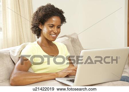 Stock Photo - Woman Using Laptop At Home. Fotosearch