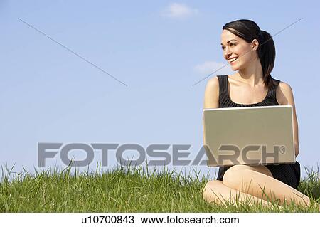 Woman Using Laptop Outdoors In Summer Countryside View Large Photo Image Stock Image - Woman Using Laptop Outdoors In Summer Countryside. Fotosearch