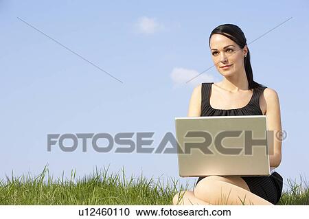 Woman Using Laptop Outdoors In Summer Countryside View Large Photo Image Stock Image - Woman Using Laptop Outdoors In Summer Countryside. Fotosearch