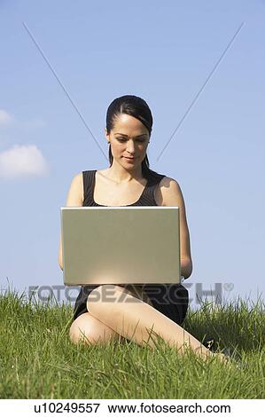 Woman Using Laptop Outdoors In Summer Countryside View Large Photo Image Stock Photo - Woman Using Laptop Outdoors In Summer Countryside. Fotosearch
