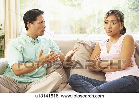 Stock Photograph - Young Couple Having Argument At Home. Fotosearch