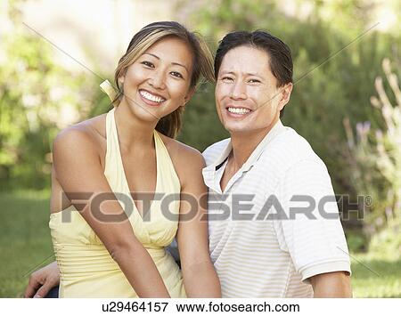 Stock Photo - Young Couple Hugging In Garden. Fotosearch