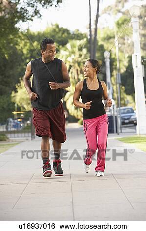 Young Couple Jogging On Street View Large Photo Image Stock Photograph - Young Couple Jogging On Street. Fotosearch